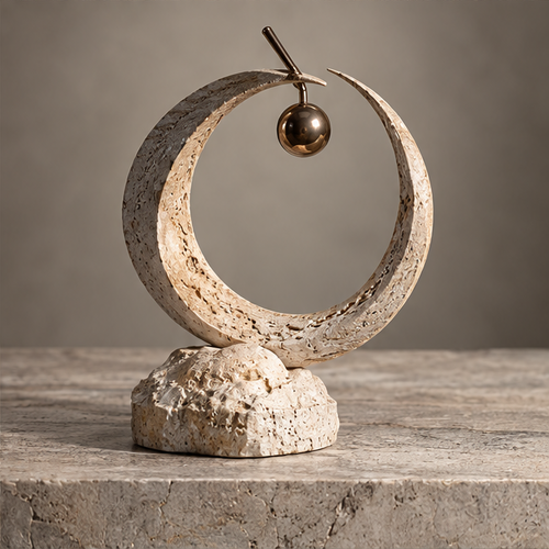 Textured ivory-toned open crescent ring sculpture with hanging bronze-toned orb and irregular rounded base, without text overlay